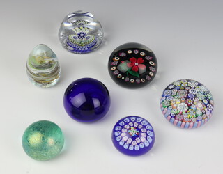 A Selkirk Glass millefiori paperweight with flowers no.31 of 100 dated 1995 8cm boxed, a millefiori paperweight by Peter McDougall 8cm, a Whitefriars style faceted paperweight with millefiori cones 8cm and 5 other paperweights inc Isle of Wight, Bristol, John Deacons, Heron Glass and a Hippocampus resin paperweight containing a carnation 