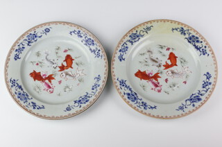 A pair of 18th Century Chinese rose plates decorated with carp 23cm (1 restored)