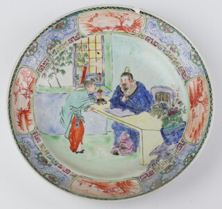 An 18th Century Chinese famille rose plate decorated with a gentleman sitting at a desk with an attendant before him, the border with ochre landscape panels 20cm 