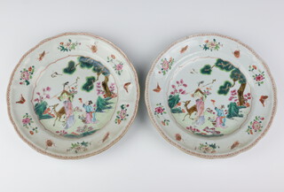 A pair of Chinese 18th Century famille rose plates decorated with ladies in a garden with a deer, the border with insects and flowers 23cm 