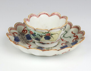 A Kangxi style fluted tea bowl and saucer decorated with panels of figures and flowers, the base with rabbit mark  