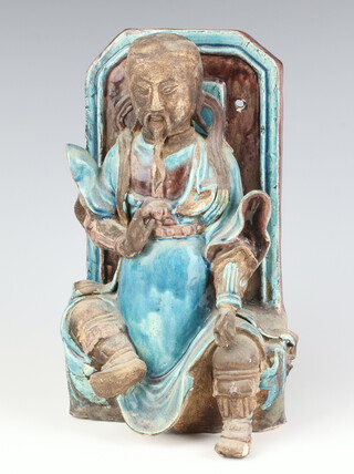 A Tang style wall mounting turquoise slip glazed figure of a seated deity 23cm (a/f)