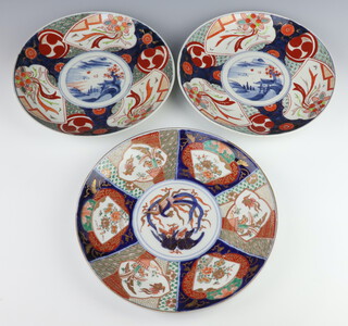 A circular Japanese Imari charger with segmented decoration and birds to the centre 30cm, together with a ditto pair decorated buildings and mountains 8cm (gilding rubbed in places) 