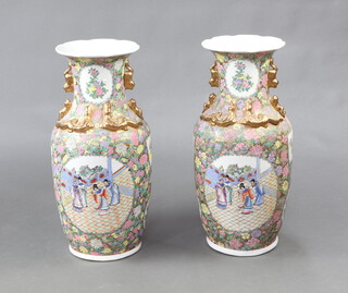 A pair of modern Cantonese style oviform vases decorated with panels of figures having lion handles 62cm 
