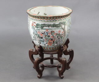 A 20th Century Chinese jardiniere, the interior decorated carp, the outside with panels of figures 32cm, complete with hardwood stand 