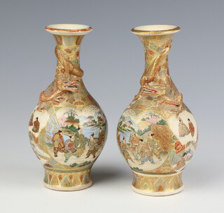 A pair of Meiji period Satsuma oviform vases decorated with panels of figures with an entwined dragon to the neck 15cm 