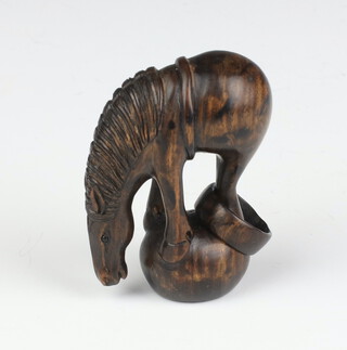 A Japanese carved hardwood Netsuke in the form of a horse with glass eyes, having a reticulated ring to his back leg, signed 4cm 