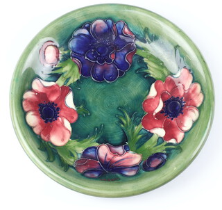 A William Moorcroft dish the green ground with anenomes, impressed marks and monogram 22cm