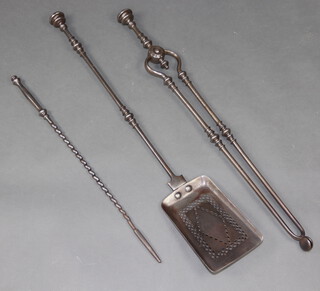 A pair of 19th Century polished steel fire tongs together with a matching shovel and a spiral turned polished steel poker 