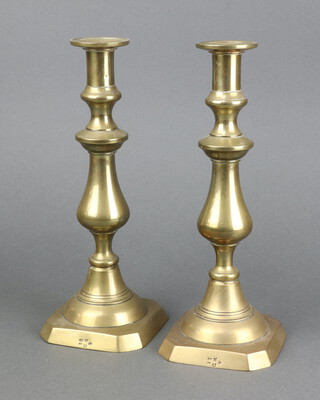 A pair of Victorian brass War Office issue candlesticks with ejectors, base with broad arrow WD51 17th Lancers, battle honours Central India at Alma, Sebastopol Balaclava and Inkerman  27cm h x 10cm w  x 10cm d 
