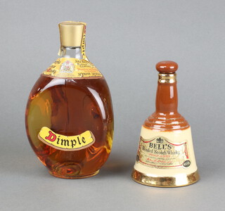 A 20 2/3 fluid oz bottle of Dimple Haig whisky together with an 18.75cl bottle of Bells Whisky contained in a Wade decanter (some liquid loss)