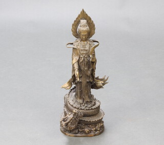 A Chinese bronze figure of the Bodhisattva Guanyin holding a vessel with dragon to the base 46cm h x 17cm x 13cm 