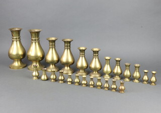 Jones and Willis, a pair of club shaped brass vases 23cm h together with 10 other graduated pairs and 2 others 