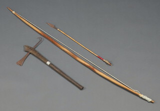 A Maasai axe with 27cm metal head and 25cm carved shaft together with a hardwood bow 135cm long (cracked) and an arrow 