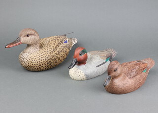 David Patrick-Brown, a carved wooden model of a Green Winged Teal, 11cm x 27cm and 1 other Green Winged Teal 11cm x 27cm together with a Nick Barrett carved and painted model of a Mallard duck 17cm x 30cm w x 11cm d 