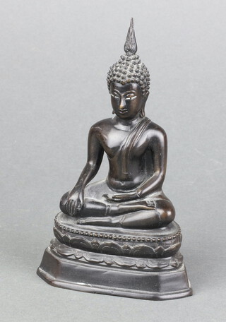 A bronze figure of a seated Buddha on an oval base 15cm x 9cm x 6cm 