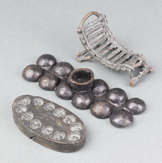 An African bronze model of a day bed 5cm h x 10cm w x 5cm d, together with an oval bronze plaque with 12 circular segments 10cm x 5cm and a rectangular ditto with 12 segments 2cm x 17cm x 8cm  