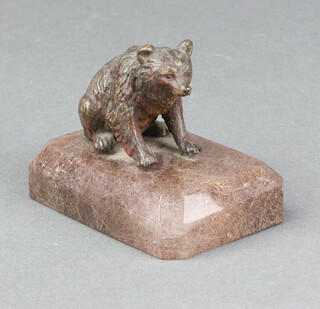 A bronze hardstone paperweight in the form of a seated bear, raised on a rectangular hardstone base 8cm h x 8cm w x 5cm 
