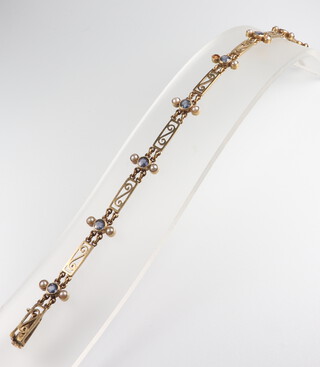 A yellow metal seed pearl and amethyst bracelet (1 pearl missing) 9.6 grams, 17cm 