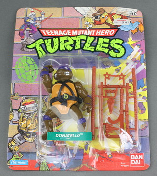 Teenage Mutant Hero Turtles, an original Playmates Bandai carded and unpunched figure of Donatello (5002) with Woolworths sticker 