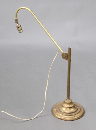 An Edwardian brass adjustable table lamp raised on a circular spreading foot, marked Bestlite, raised on circular spreading foot 70cm h x 22cm diam. 