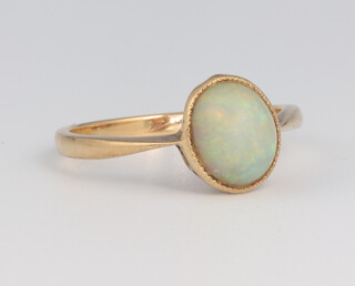 A yellow metal cabochon opal ring, size P 1/2, 3 grams