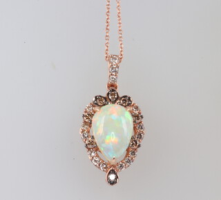 A 14ct opal and diamond drop pendant, the 23 brilliant cut diamonds approx. 0.6ct, the pear cut opal 2.25ct, 15mm x 8mm, the pendant 3cm, on a 14ct yellow gold chain 44cm, 5.8 grams