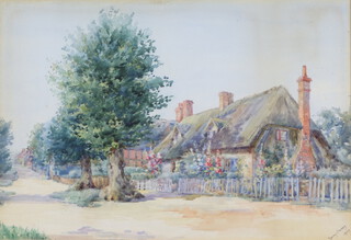 Nancy Casey, watercolour, study of a thatched cottage with picket fence, signed and dated 1909 to right hand corner 23cm x 34cm 