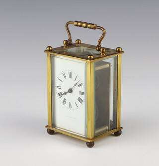 A carriage clock with enamelled dial Roman numerals, contained in a gilt case complete with key 10cm x 7cm x 6cm 