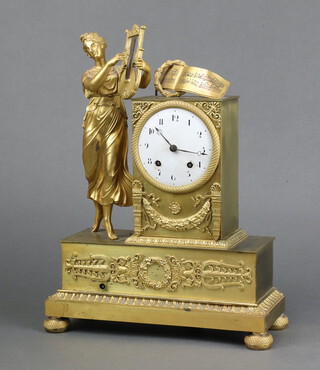 An Empire musical mantel clock striking on 2 bells with silk suspension, in the form of a classical pedestal, the 9cm enamelled dial with Arabic numerals, the base fitted a musical box playing The Blue Danube, with figure of lady depicting music to the side 37cm x 28cm x 11cm  