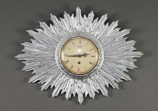 A 1940's 8 day wall timepiece, the 12cm paper dial with Roman numerals, contained in a silver painted plaster sunburst case 45cm x 32cm 