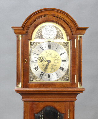 A reproduction Georgian style chiming longcase clock, the 20cm arched gilt dial with silvered chapter ring, contained in a walnut case with sliding hood 172cm h x 32cm w x 20cm d, pendulum is missing an attachment 