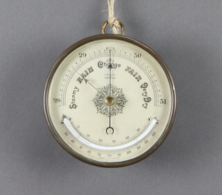 A 19th/20th Century aneroid barometer with 12cm silvered dial, contained in a gilt metal case 