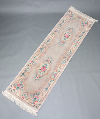 A mushroom ground and floral patterned Chinese runner 240cm x 73cm  