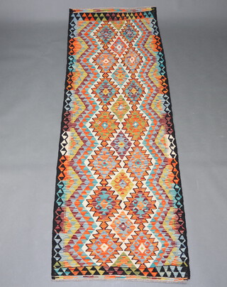 A tan, turquoise and green ground Chobi Kilim runner with overall diamond design 240cm x 83cm 