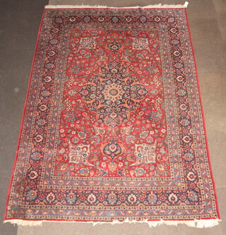 A red and blue ground Persian rug with central medallion within a multi row border 303cm x 212cm  