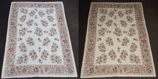 A pair of cream ground and oak leaf patterned Aubusson style rugs 267cm x 186cm 