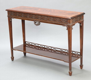 A Victorian Chippendale style rosewood side table with blind fretwork decoration, the under tier with pierced gallery to the back, raised on square tapered supports, spade feet 84cm h x 120cm w x 36cm d 