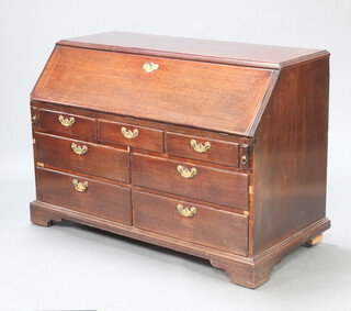 A Georgian mahogany estate style bureau, the fall front revealing a well fitted interior above 3 short and 4 long drawers, raised on bracket feet 93cm h x 133cm w x 64cm d 