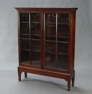 A 19th Century mahogany bookcase with moulded and dentil cornice, fitted adjustable shelves enclosed by astragal glazed panelled doors, raised on a later stand, spade feet, 142cm h x 112cm w x 29cm d 