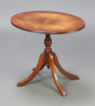 A Georgian style oval crossbanded mahogany snap top wine table, raised on a pillar and tripod base 48cm h x 53cm w x 49cm d 