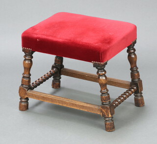 An 18th Century style rectangular oak framed stool, the seat upholstered in red material, raised on outswept turned and block supports with box framed stretcher 42cm h x 55cm w x 35cm d 