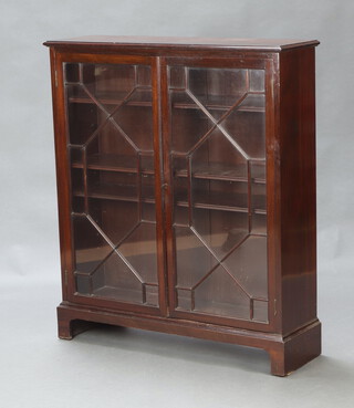 A Georgian style mahogany bookcase, fitted shelves enclosed by astragal glazed panelled doors, raised on bracket feet 107cm h x 92cm w x 27cm d 