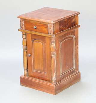 A Victorian style hardwood bedside cabinet fitted a drawer above cupboard enclosed by arched panelled door and with columns to the sides 65cm h x 40cm w x 40cm d 