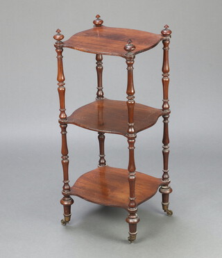 A Victorian rosewood 3 tier what-not of serpentine outline, raised on turned supports 86cm h x 36cm w x 32cm d 