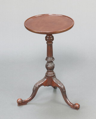 An Edwardian Chippendale style circular mahogany wine table, raised on turned and fluted column with tripod base  59cm h x 33cm diam. 
