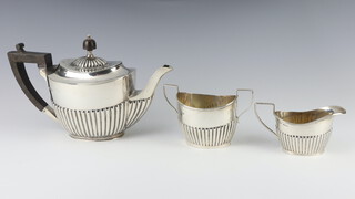 An Edwardian silver 3 part breakfast tea set with ebony mounts and demi-fluted decoration Sheffield 1909, 665 grams 