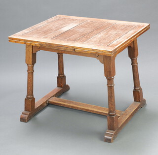 An Art Nouveau bleached oak drawleaf dining table, raised on outswept turned and block supports with H framed stretcher 76cm h x 91cm l x 76cm w 