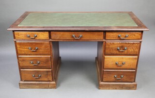 A Victorian style mahogany kneehole pedestal desk with green inset writing surface above 1 long and 8 short drawers 76cm h x 143cm w x 68cm d  