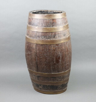 An oval oak coopered stick stand in the form a barrel, the back marked MC, 63cm h x 28cm w x 21cm d, 